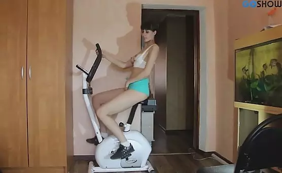 Fit Brunette Rides Stationary Bike to Orgasmic Climax